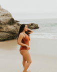 Cute, modest rust colored one piece swimsuit, with ties in the back and front.