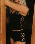Textured modest black tankini top with floral cutouts.