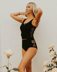 Textured modest black tankini top with floral cutouts.