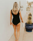 Textured modest black tankini top with floral cutouts.