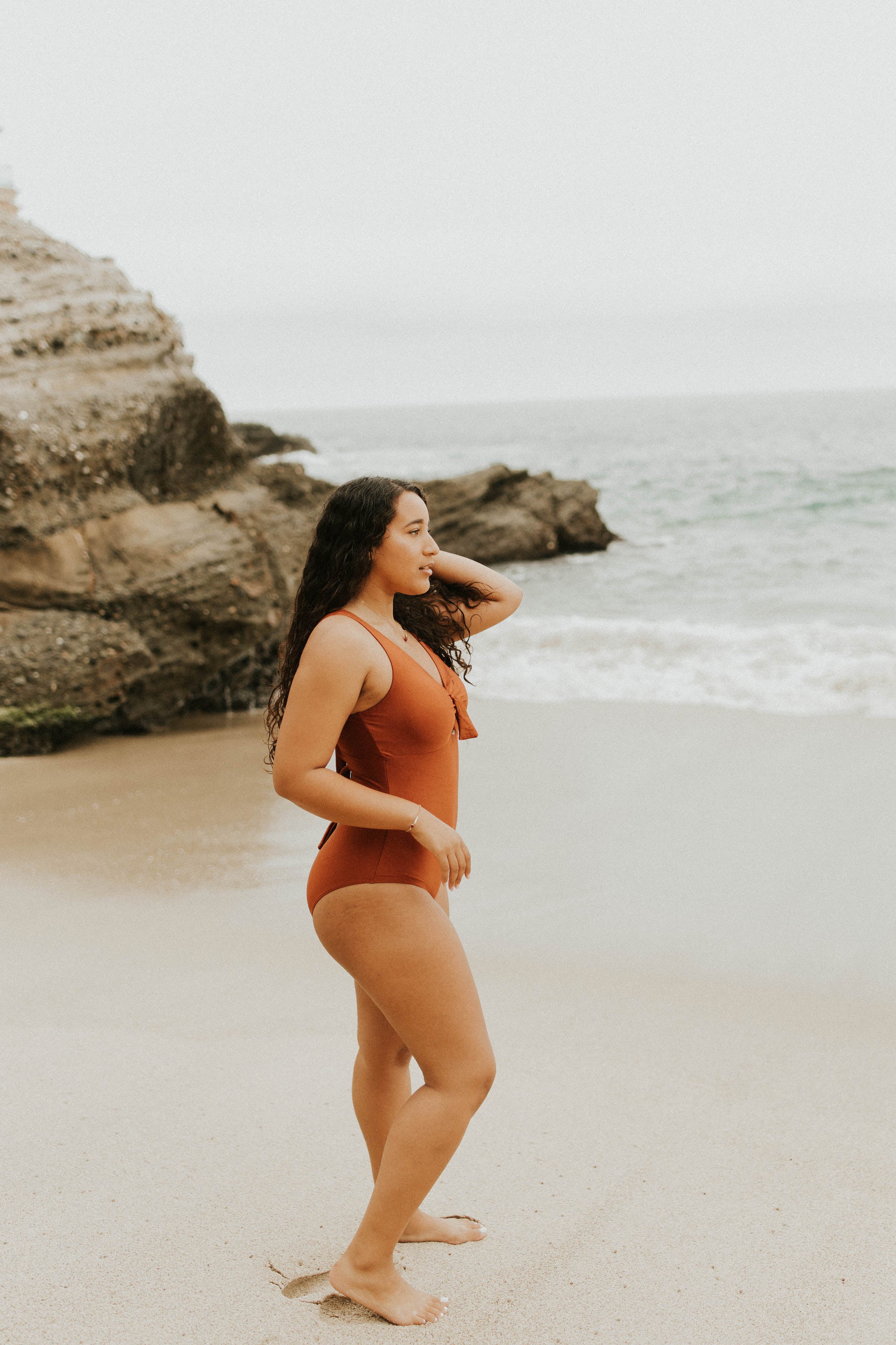Cute, modest rust colored one piece swimsuit, with ties in the back and front. 