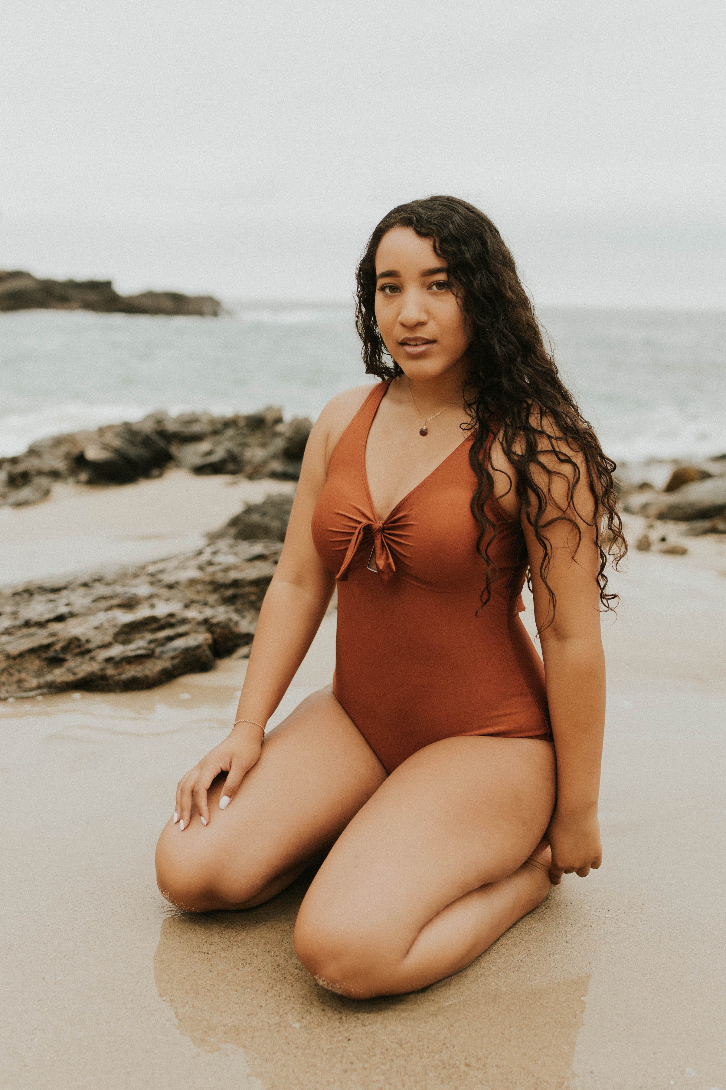 Cute, modest rust colored one piece swimsuit, with ties in the back and front. 